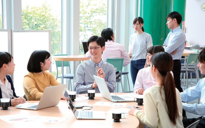 Smiling charismatic speaker giving public presentation in conference hall